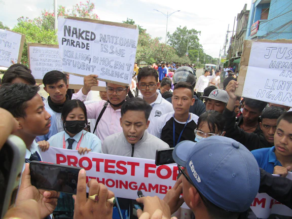 A group of determined South Sudanese activists holding handmade signs during a peaceful protest.