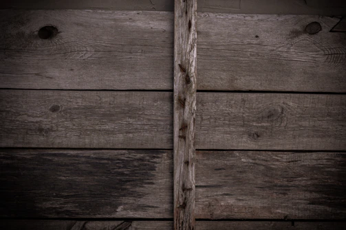 Hand-forged nails and screws arranged on aged wood.