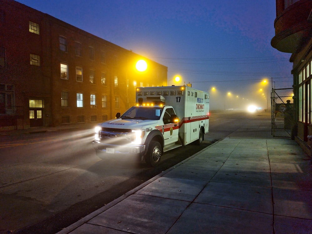 a white ambulance parked on the side of a road
