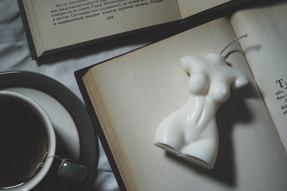 a book with a bookmark and a cup of coffee