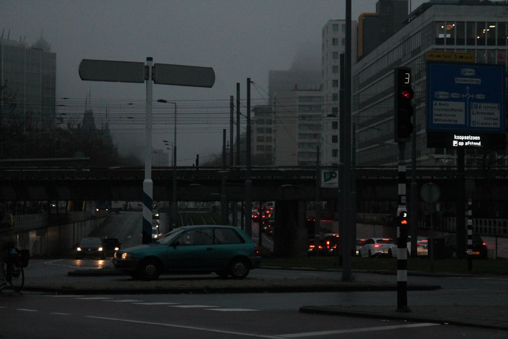 a car driving down a street next to a traffic light