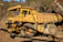 A rugged heavy-duty truck from Starkraft’s fleet navigating a mountainous construction site.