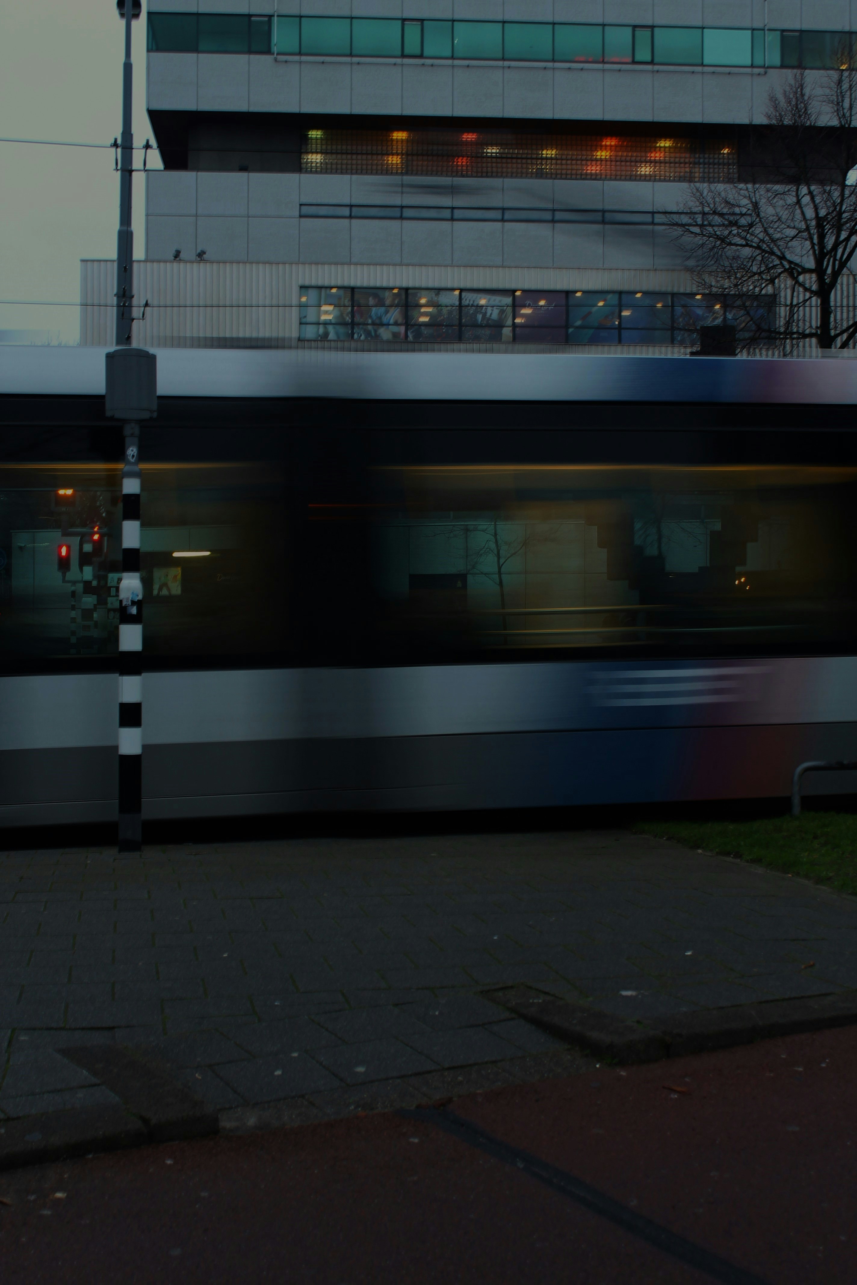 a blurry photo of a train passing by a building