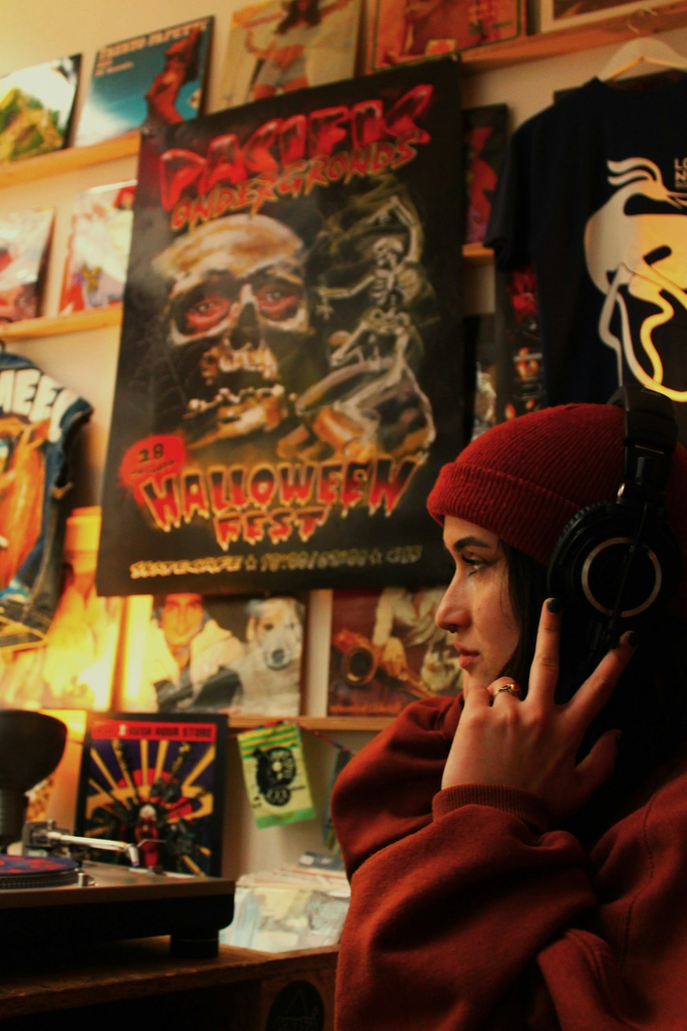 a woman in a red hoodie listening to headphones