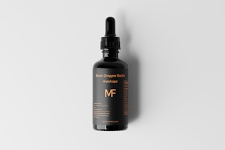 a bottle of mf hair growth oil on a white background