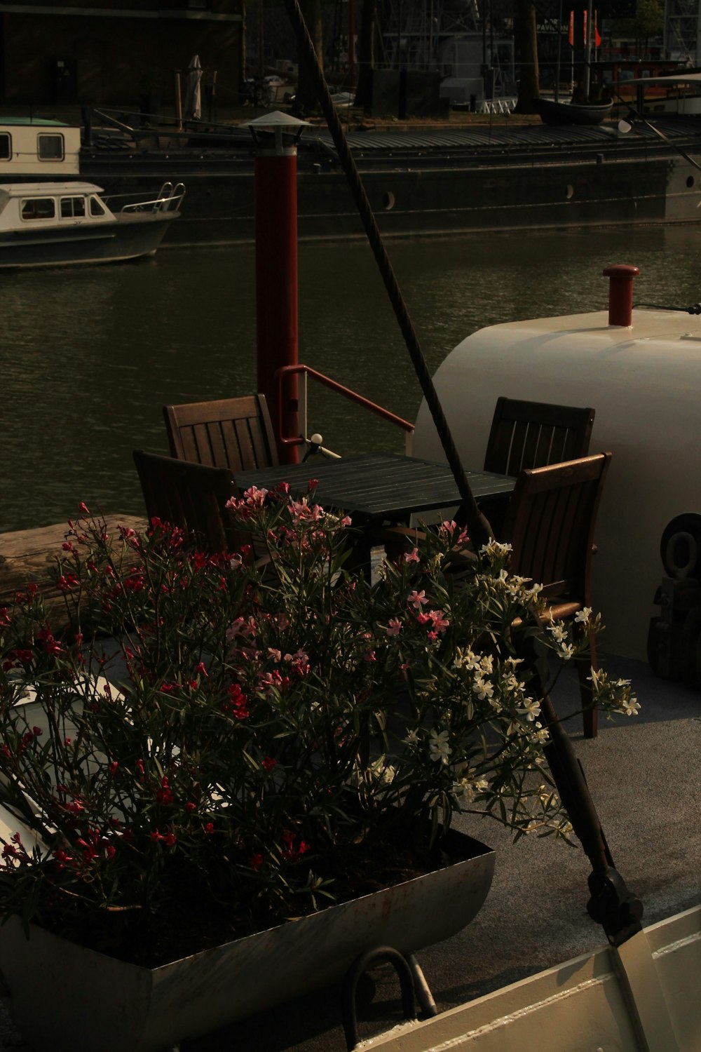 a boat docked at a dock with a table and chairs
