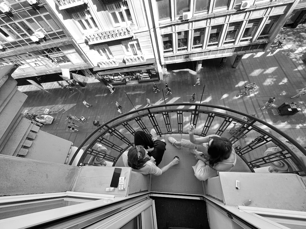 a couple of people that are standing on some stairs