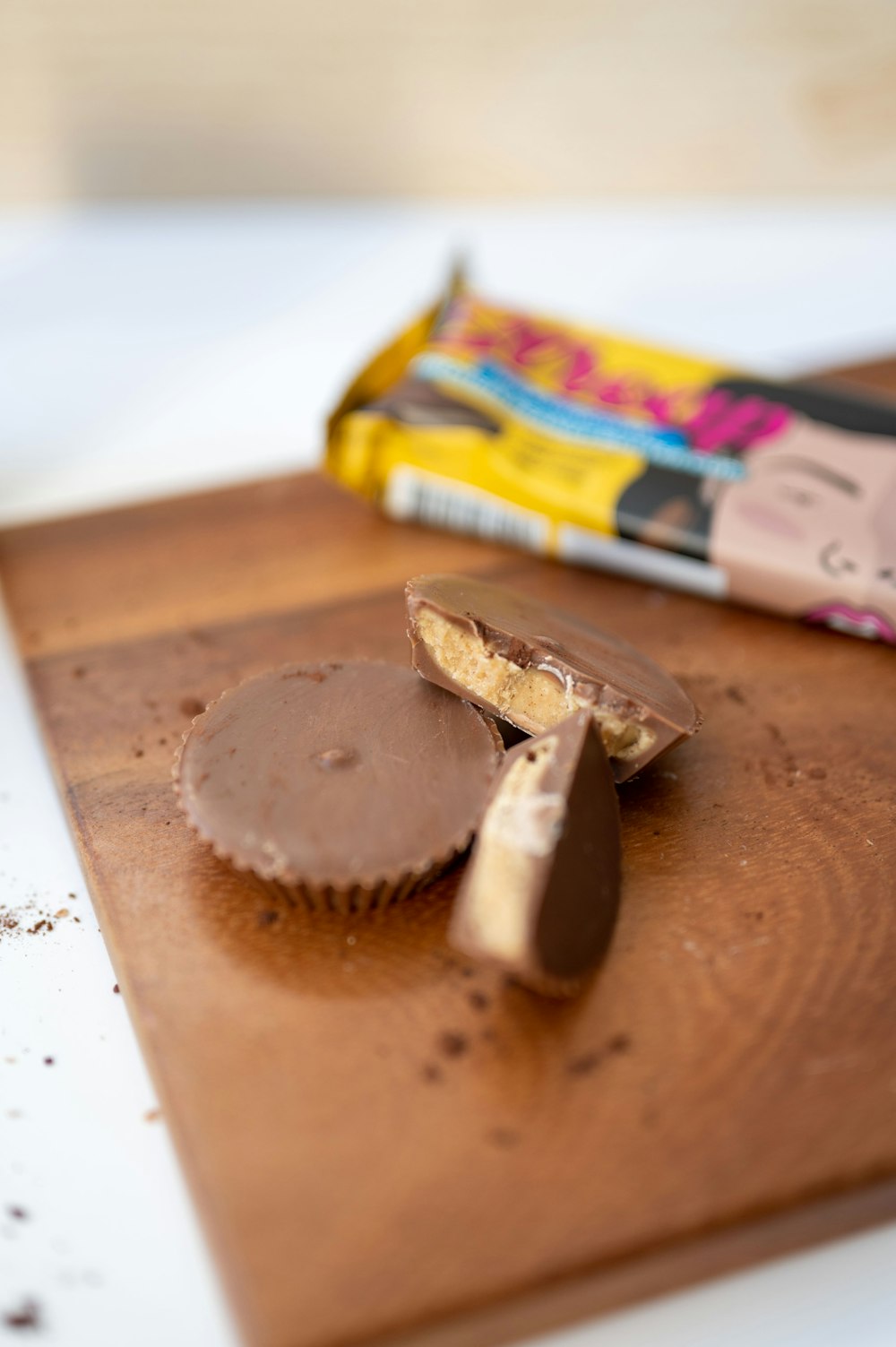 a wooden cutting board topped with a piece of chocolate