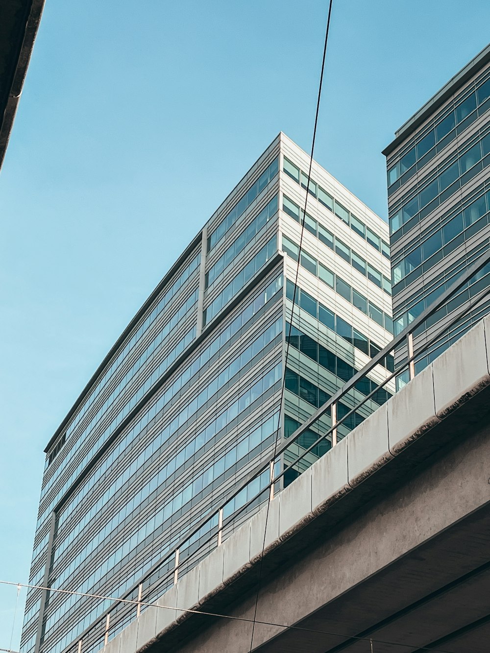 a very tall building sitting next to a bridge