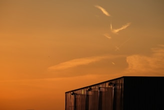 Clean and professional team applying custom metal j-channel trim under an orange sunset.