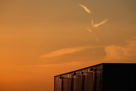Clean and professional team applying custom metal j-channel trim under an orange sunset.