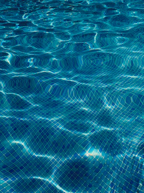 Before and after images of a cracked pool tile replaced flawlessly