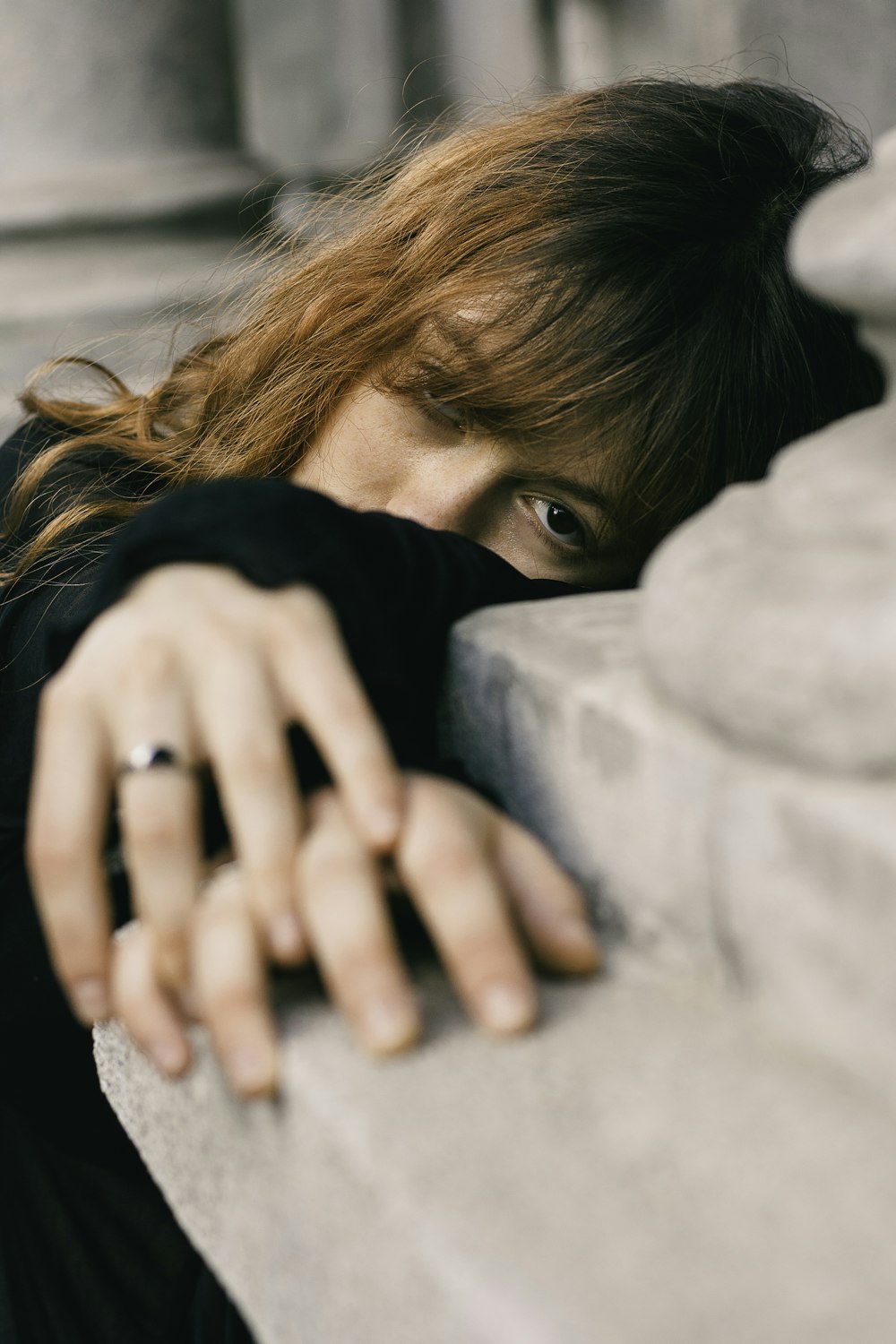 a woman leaning against a wall with her hand on the wall