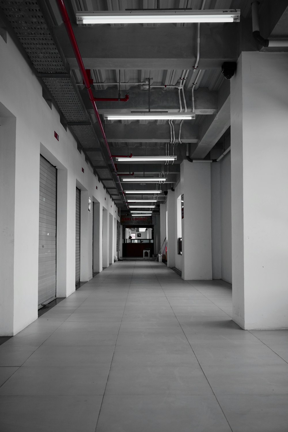 a black and white photo of a long hallway