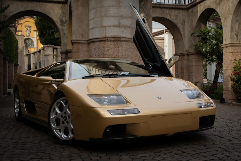 A sleek Innova Reborn parked in front of a popular tourist spot with a friendly driver opening the door.