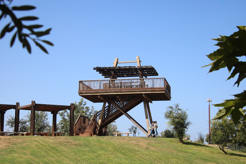 a wooden structure on top of a hill