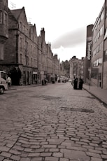 a black and white photo of a cobblestone street