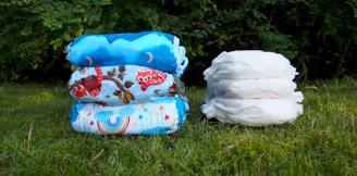 A cozy setup showing two different cloth diaper starter kits neatly arranged on a wooden table.
