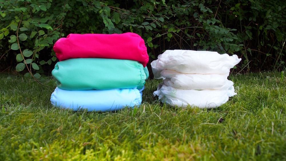 a pile of cloth sitting on top of a lush green field