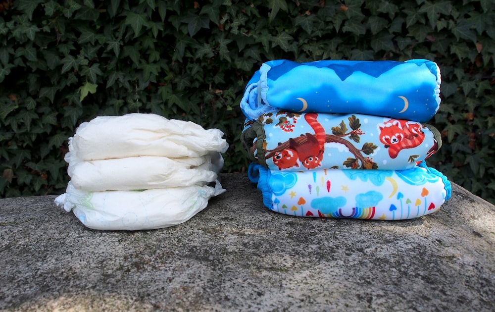 a pile of diapers sitting on top of a rock