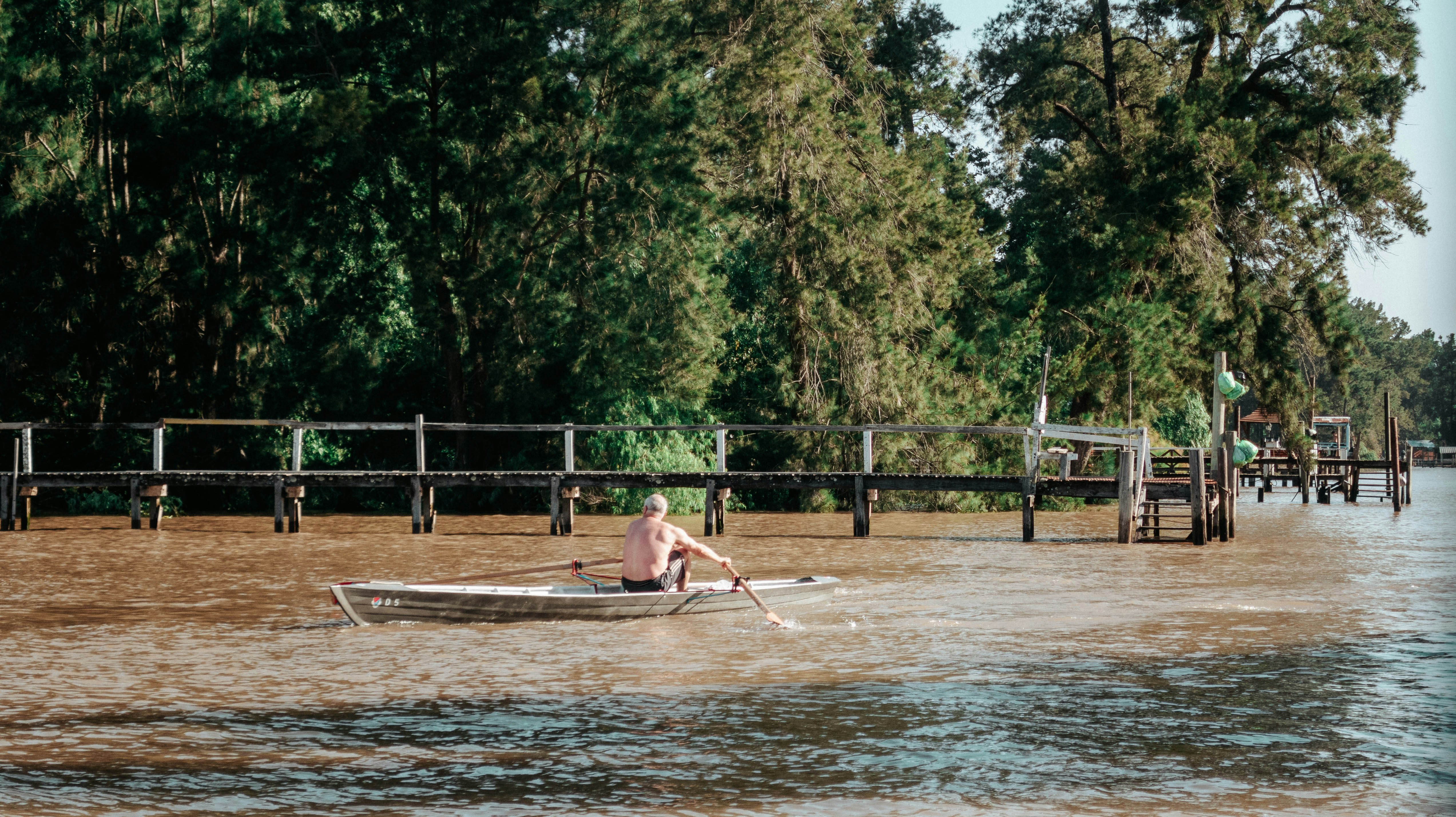 a man is rowing a boat in a body of water
