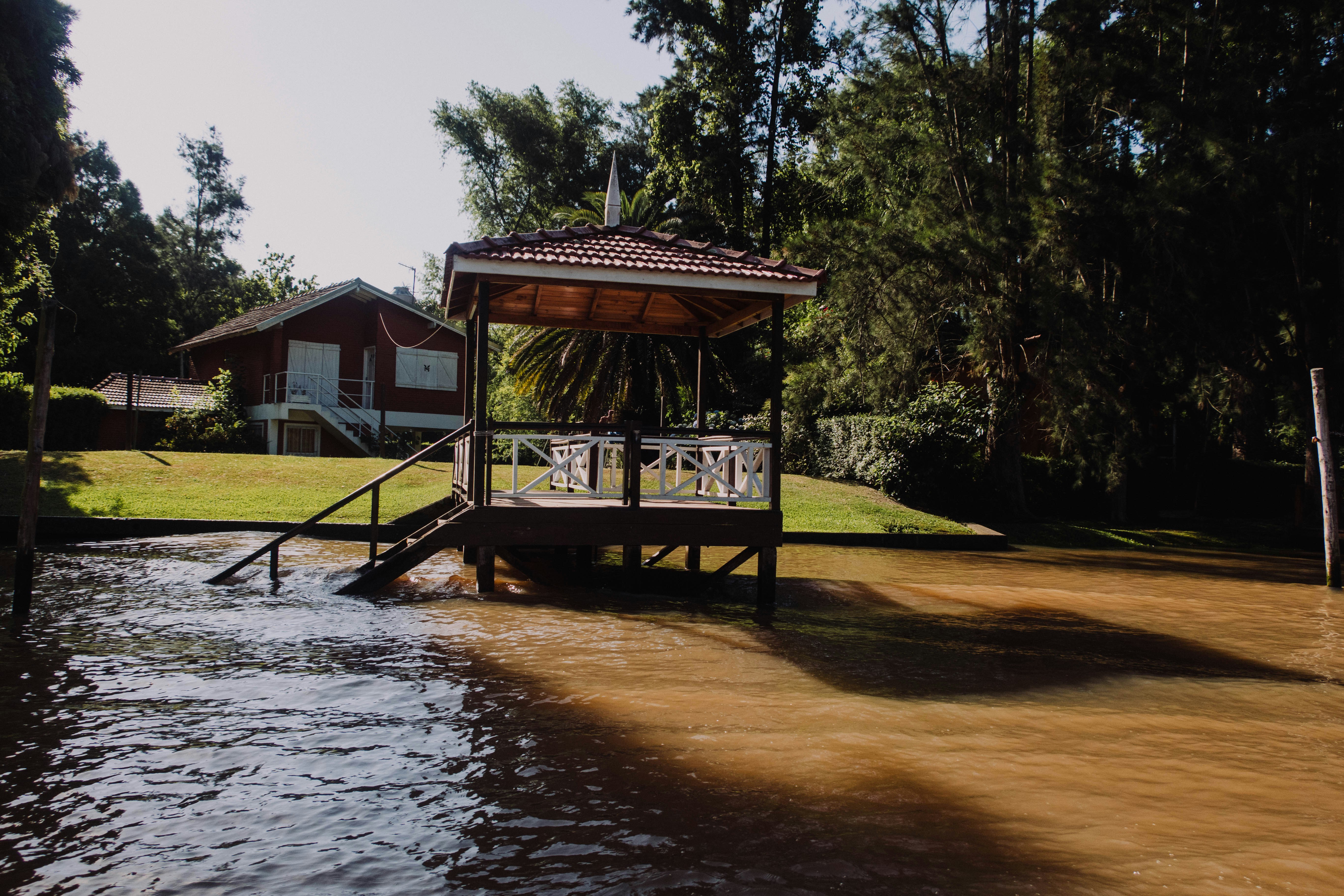 a gazebo sitting in the middle of a body of water