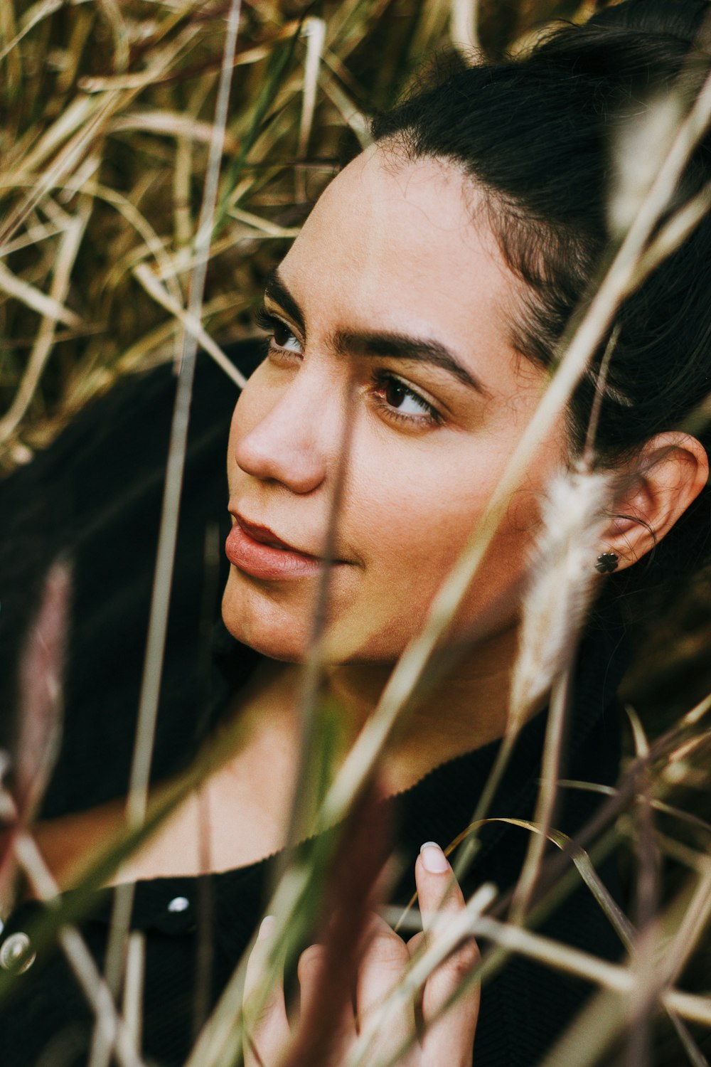 a woman standing in a field of tall grass