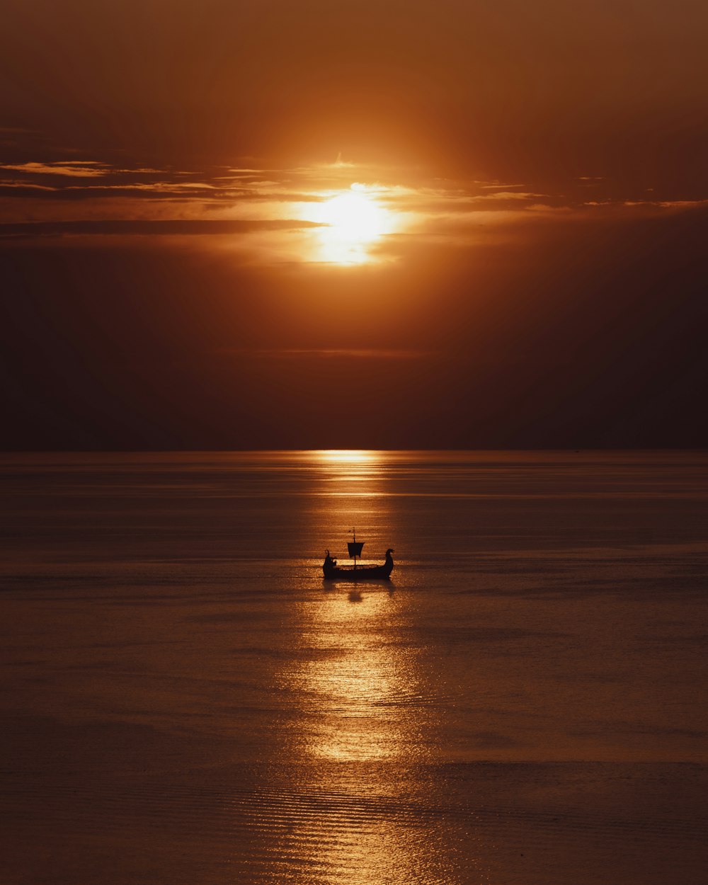 a person in a small boat on a large body of water