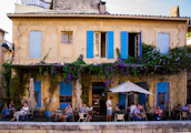 A cozy café terrace in Marseille where people casually meet and chat.