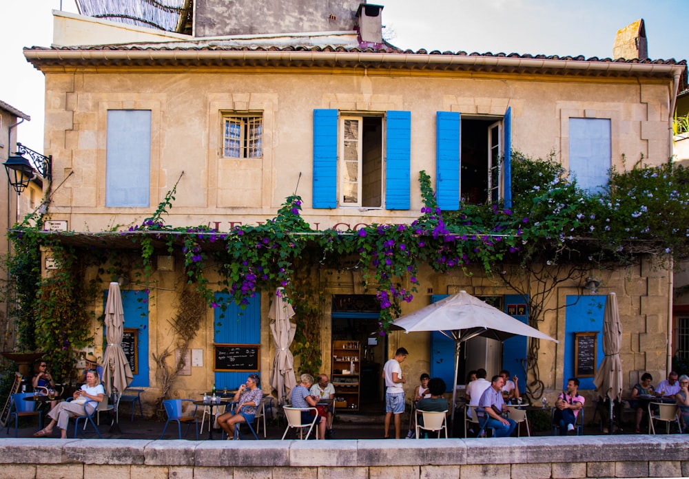 a group of people sitting outside of a building