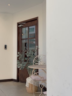 A warm, inviting home entryway with a cozy chair and a small plant by the door.