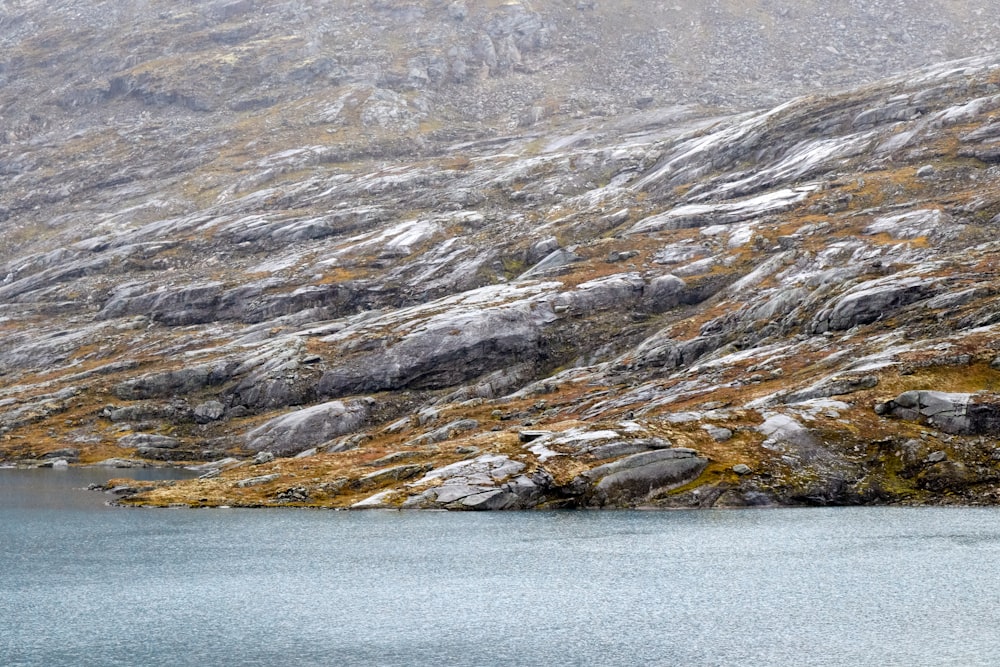 a mountain with a body of water in the foreground