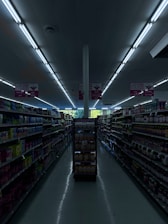 A cozy small grocery store aisle filled with fresh fruits, vegetables, and local products.