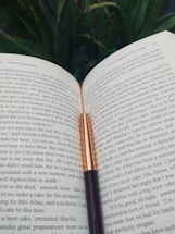 A welcoming image of an open book with a quill, symbolizing communication.