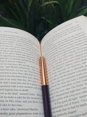 A welcoming image of an open book with a quill, symbolizing communication.