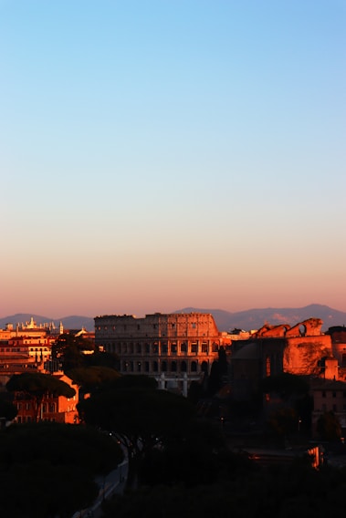 A vibrant sunset over the ancient Greek Theatre of Taormina, Sicily.