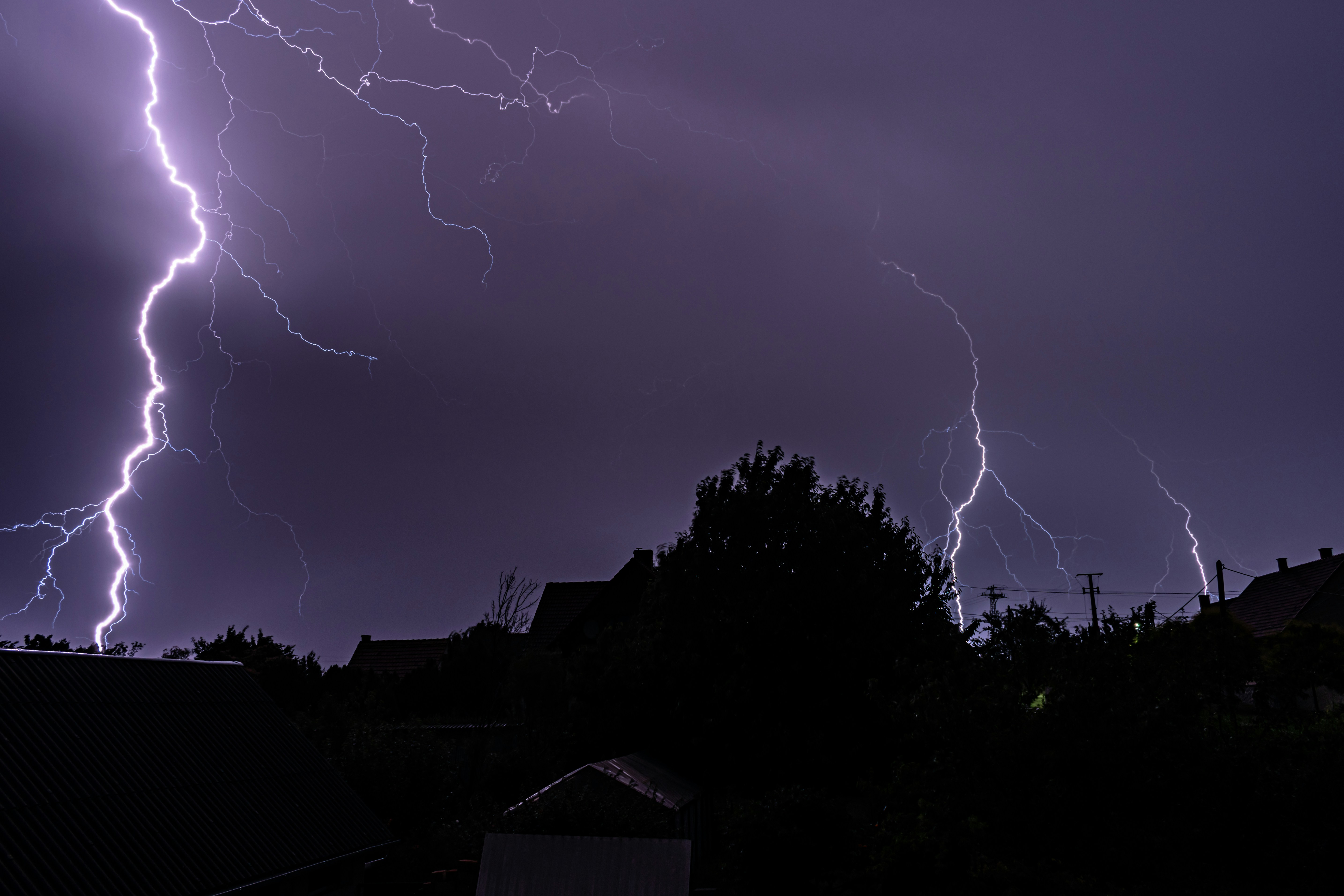 A lightning storm is seen over a residential area, 