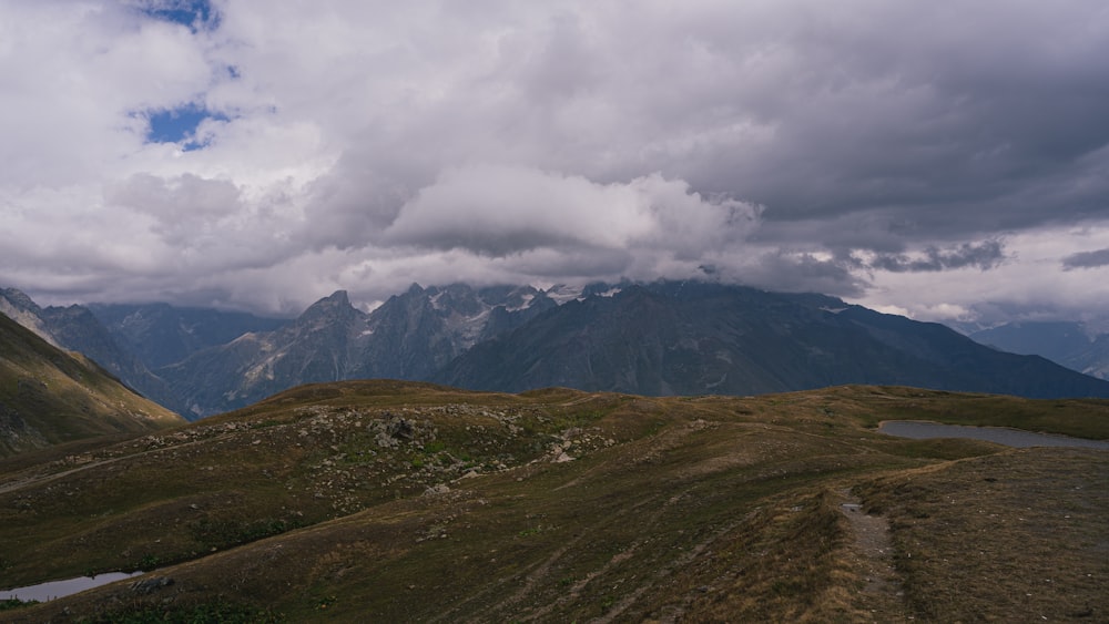 a view of a mountain range with a lake in the foreground