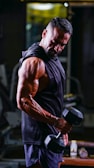 Close-up of muscular man lifting heavy weights in a gym with intense focus
