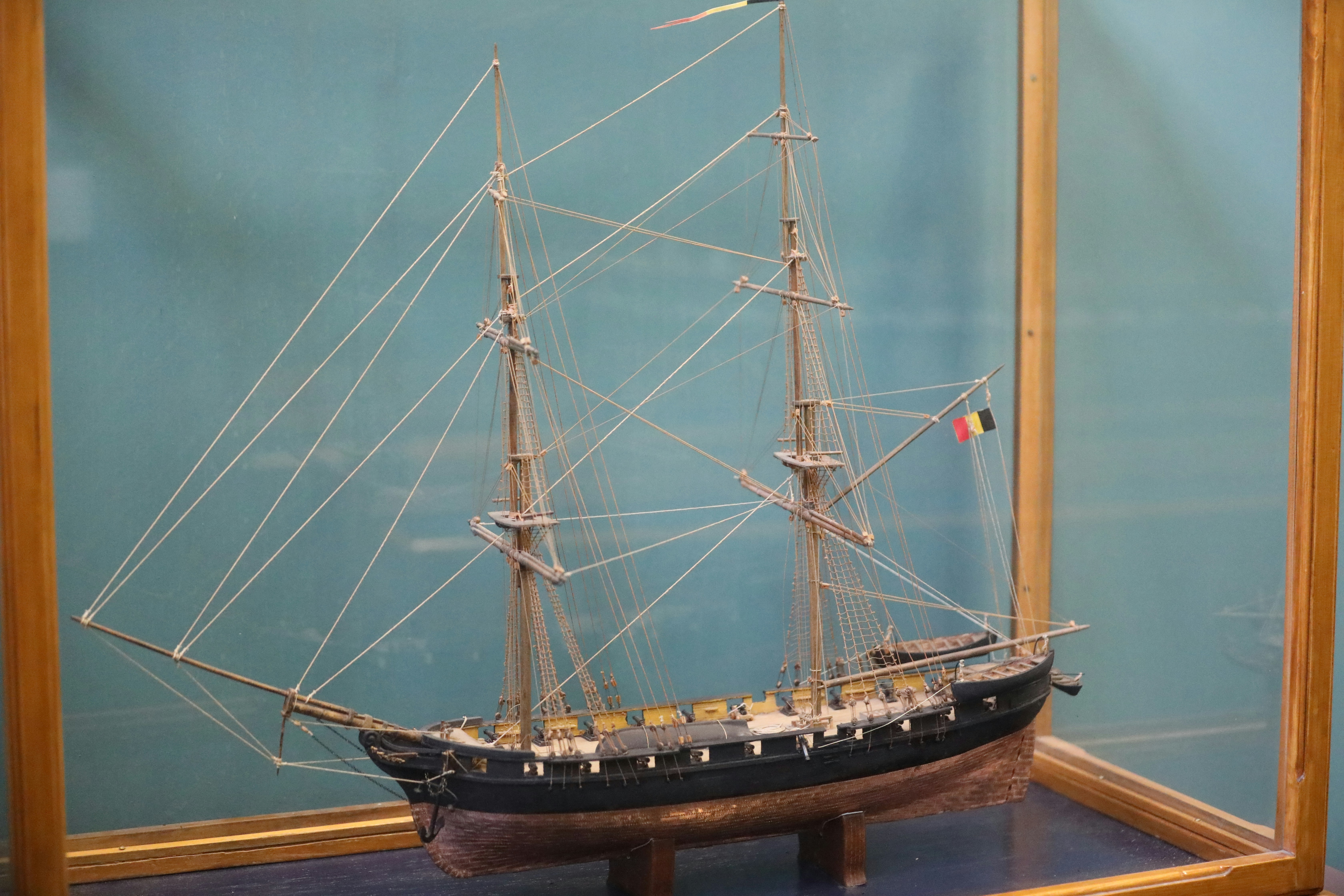 a model of a sailing ship in a glass case