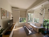 Bright living room with modern furniture and large windows.