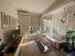 A bright, modern living room with sleek furniture and natural light.