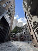 a city street with tall buildings in the background