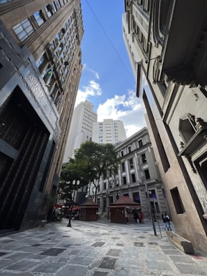 a city street with tall buildings in the background