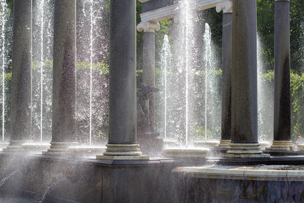 a group of pillars with water shooting out of them