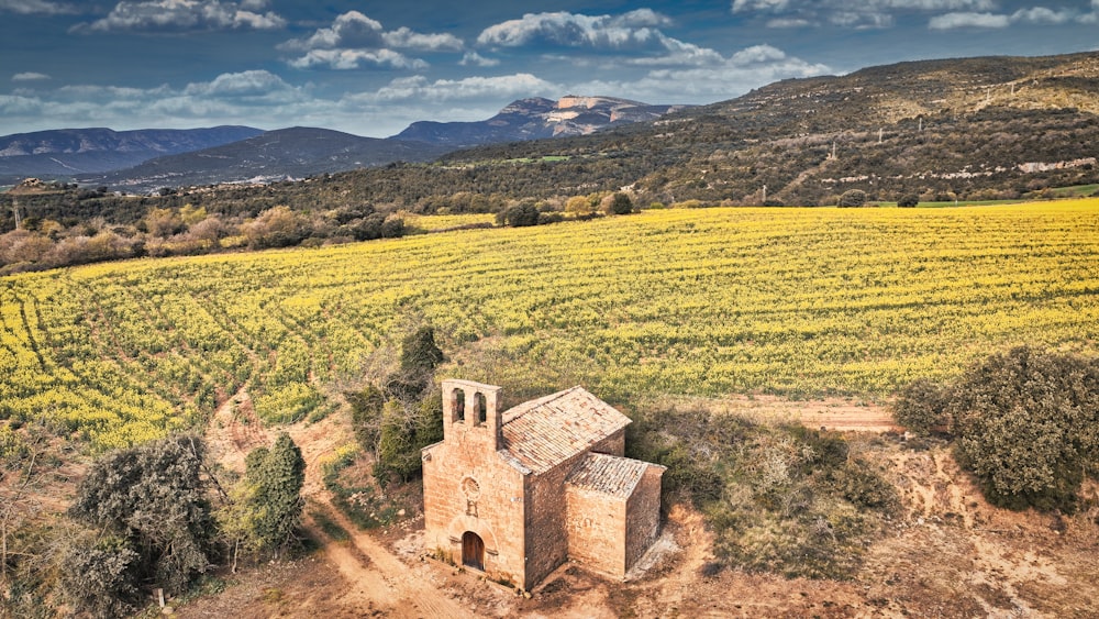 an aerial view of a church in the middle of a field