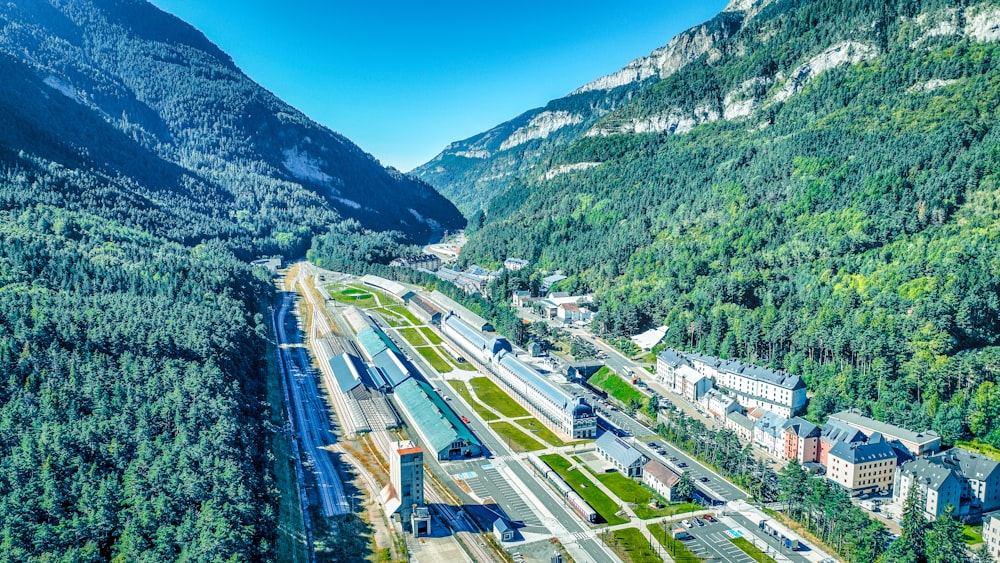 an aerial view of a town surrounded by mountains