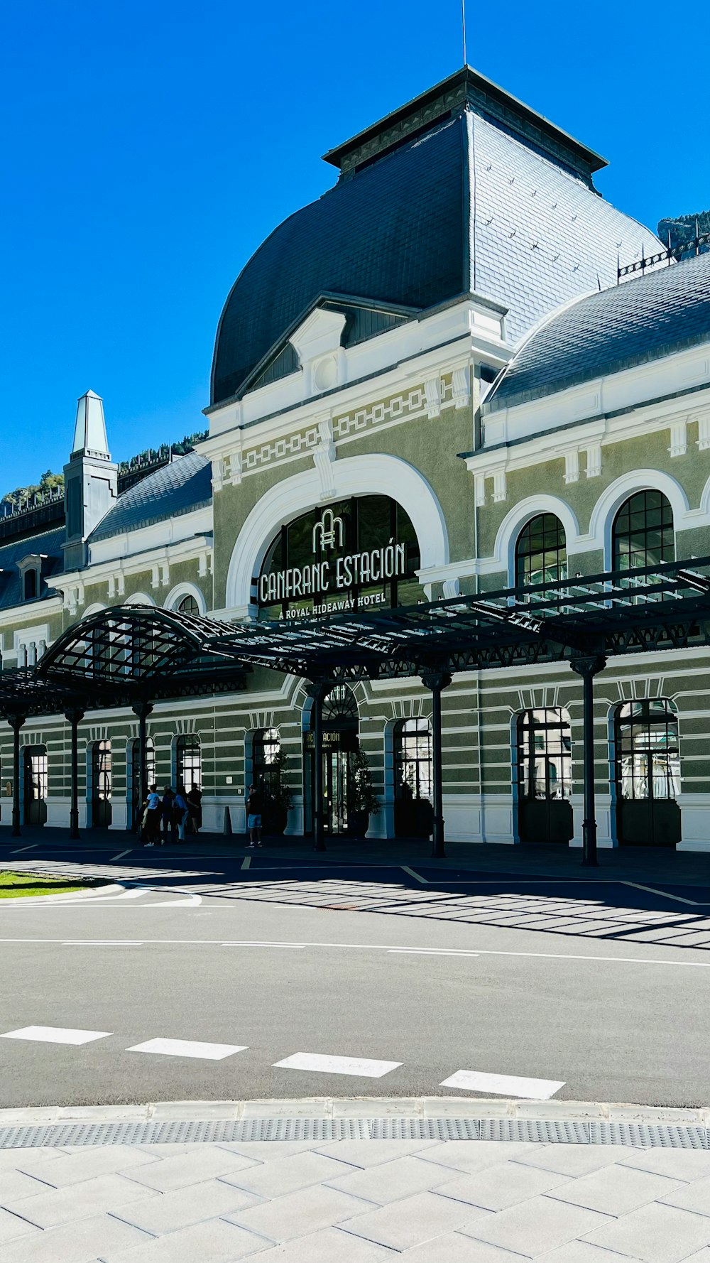 a train station with a clock on the front of it