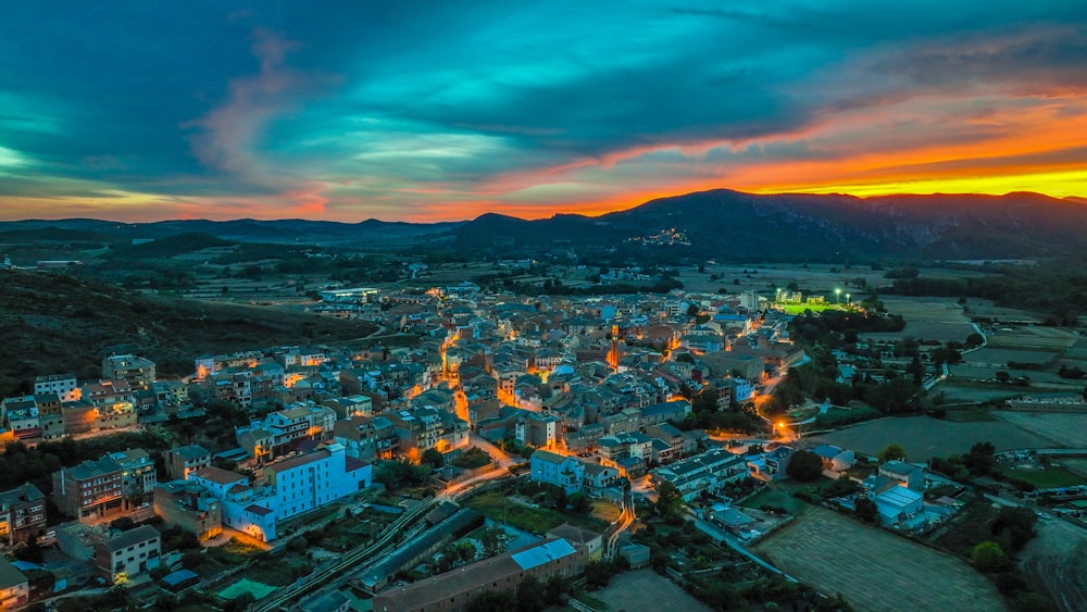 an aerial view of a city with mountains in the background