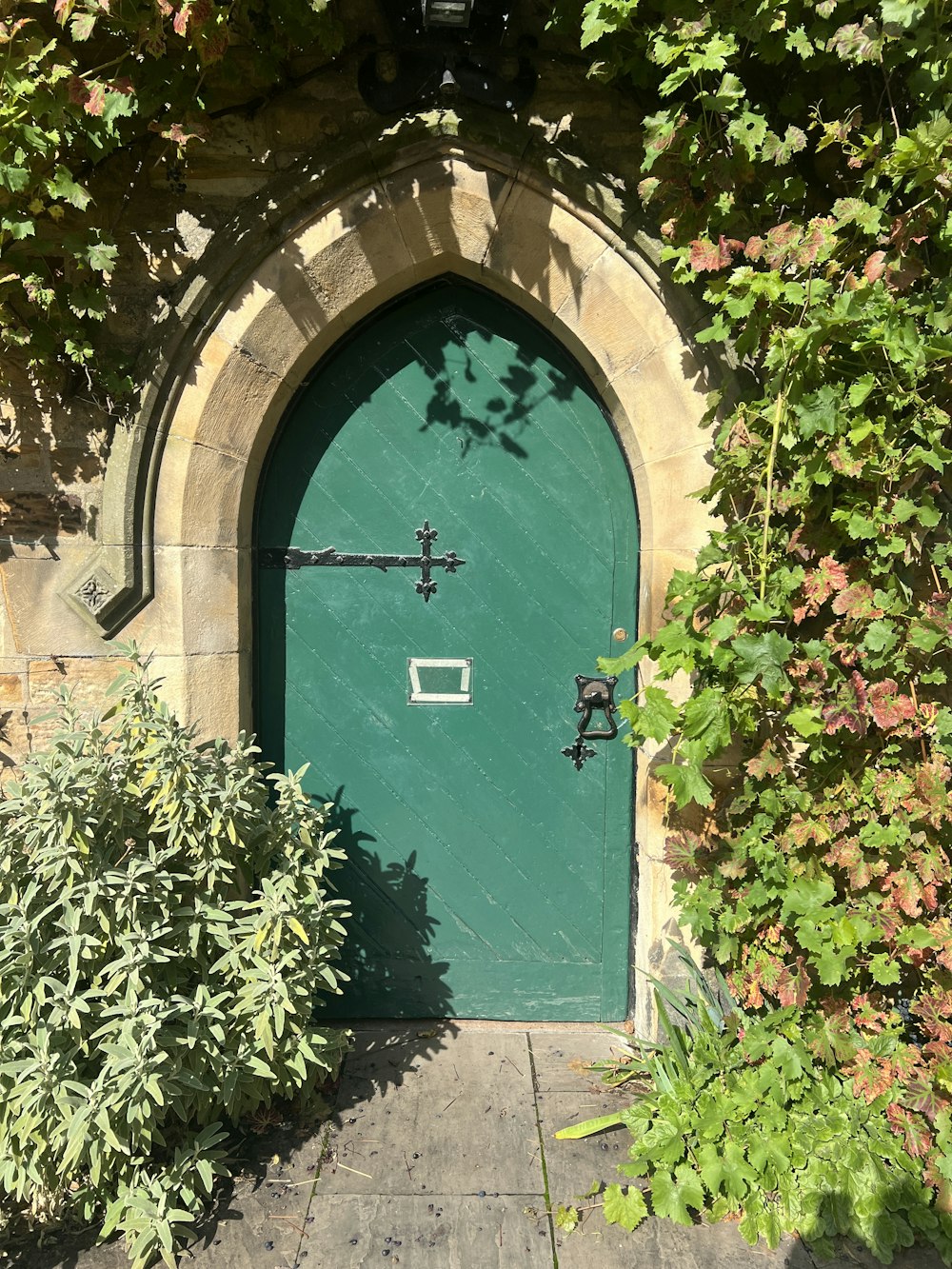 a green door with a cross on it